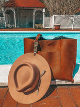 Load image into Gallery viewer, Tan leather snakeskin hat clip attaching hat to bag at poolside

