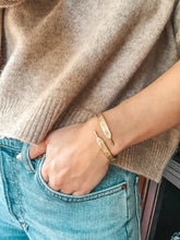 Load image into Gallery viewer, Image of gold shoelace cuff on wrist