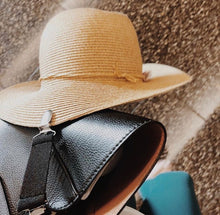 Load image into Gallery viewer, straw hat attached to bag with hat clip at airport
