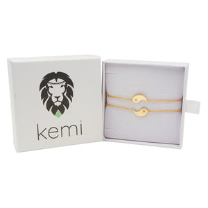 Gold bracelet in a 'kemi' branded box on a white background