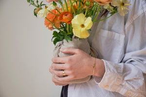 Women holding flowers with serpent ring and bracelet