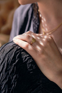 Serpent signet ring on finger